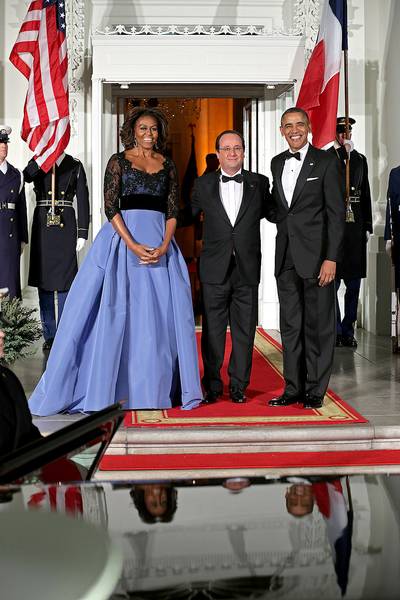 France State Dinner - The first lady wore this intricate beaded black bodice and full skirt in liberty blue to the state dinner honoring French President François Hollande on Feb. 11, 2014. The gown was designed by Venezuelan designer Carolina Herrera. (Photo: Chip Somodevilla/Getty Images)