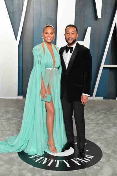 Chrissy Teigen&nbsp;and&nbsp;John Legend - Lovely couple, Chrissy Teigen and John Legend are demanding attention in their fabulous evening attire. Most noticeably, Chrissy stunned in a brightly colored Georges Hobeika gown.(Photo by George Pimentel/Getty Images) (Photo by George Pimentel/Getty Images)