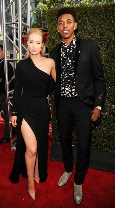 Iggy Azalea and Nick Young - Sports stars and more celebs brought their A game to the 2014 ESPY Awards in Los Angeles on Wednesday (July 16). See which stars' looks were game-changers. By Britt Middleton  The “Fancy” MC, in a thigh-baring Elie Saab dress and Jennifer Fisher jewels, strikes a winning pose with her Los Angeles Lakers star boo, who looks equally good in his slim suit, printed dress shirt and glittering gold wingtips.  (Photo: Kevin Mazur/WireImage)