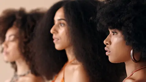 Side profile, model and natural beauty of Black women standing with afro hair. 