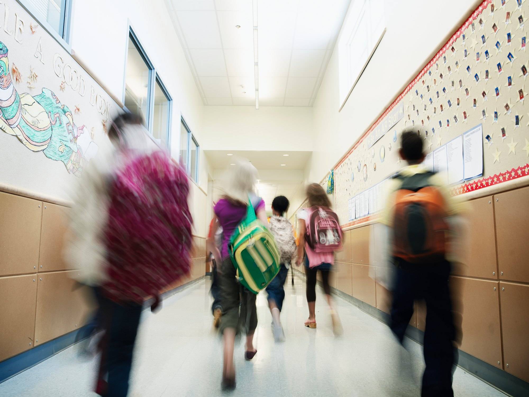 Young students walking down hallway of elementary school
