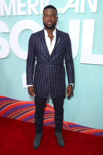 Sinqua Walls stops for pictures on the red carpet. - (Photo by Leon Bennett/Getty Images for BET)