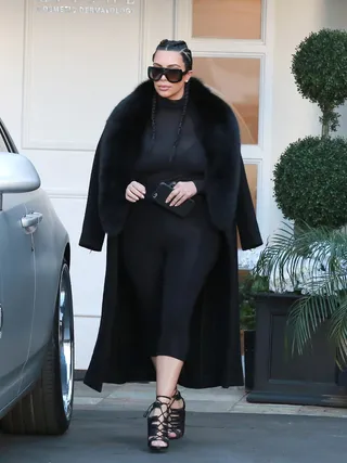 Strut - Kim Kardashian rocked her postnatal uniform of a thick black coat and cornrows while visiting a salon in Beverly Hills.&nbsp;(Photo: PacificCoastNews)