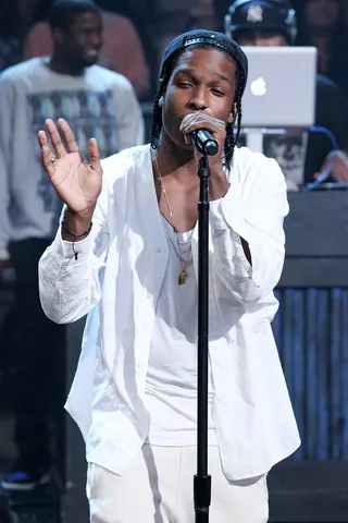 Harlem's Hero - A$AP Rocky, looking right in bright white, performs his single "Goldie" while backed by the Late Night With Jimmy Fallon house band, the legendary Roots crew. The A$AP Mob group album&nbsp;Lords Never Worry&nbsp;is set for release on August 28.   (Photo: Lloyd Bishop/NBC/NBCU Photo Bank)