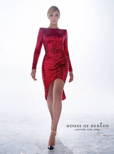 Red Hot - The label?s Fall/Winter 2012 collection is stocked with bold silhouettes and a whole lot of edge. Check out the curvy singer in this&nbsp;shimmery red hi-low dress with a straight neckline and dramatic shoulders.  The House of Der?on&nbsp;label, designed by Beyonc? and mother and stylist Tina Knowles, has scored a home run this season. The entire collection is haute! Seriously.&nbsp;By: Metanoya Z. Webb  (Photo: Courtesy House Of Dereon)