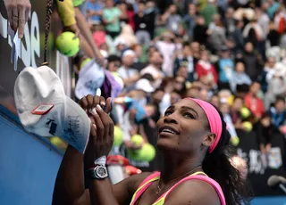 Victorious - Serena Williams signs autographs as she celebrates her win in the women's singles match against Spain's Garbine Muguruza on day eight of the 2015 Australian Open tennis tournament in Melbourne.(Photo: MANAN VATSYAYANA/AFP/Getty Images)