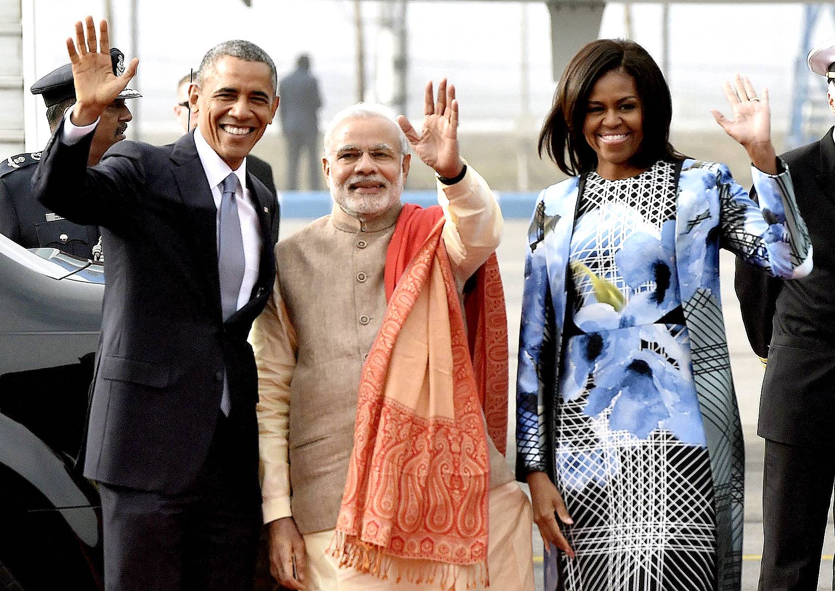 Narendra and Barack Who? - The president and first lady and Indian Prime Minister Narendra Modi wave as they arrive at Palam airport in New Delhi. The first lady, who has no official duties on this trip, dazzled the nation's fashion watchers the moment she stepped off of Air Force One in this floral dress and matching coat by Bibhu Mohapatra, a famous Indian-American designer who lives in New York. And rumor has it that the nation's weavers are planning to send the first lady 100 saris they've been working on for months.(Photo: EPA/STR /Landov)