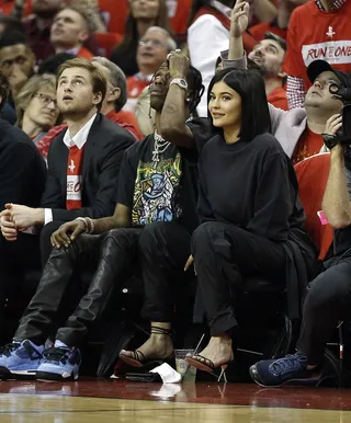 Kylie Jenner and Travis Scott - Travis and Kylie took a break from parenting for a date night at the Minnesota Timberwolves vs. the Houston Rockets game in Houston. When the couple was shown on the big screen, it looked like Kylie was waiting for some PDA and the rapper was not having it! (Photo: Bob Levey/Getty Images)