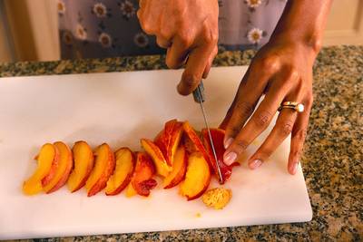 Swapping Out Foods - Love chips? Slice some sweet potatoes, brown potatoes or throw some kale in a toaster oven, drizzle some olive oil and a pinch of salt and there you go. If sugar is what you crave, opt for a piece of fruit such as a peach or apple to get that sweetness. Instead of that granola bar, eat some walnuts or almonds. Kiss cold cuts goodbye and grill your own chicken breast for your next sandwich.&nbsp;(Photo:&nbsp;Reed Kaestner/Corbis)