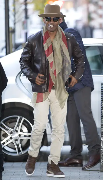 A Dapper Gent - The multi-talented star of the holiday season's biggest film, Annie,&nbsp;Jamie Foxx&nbsp;arrives at Radio 1 in London wearing a beautiful brim, complementary sneakers and a beautiful antiqued American flag scarf.(Photo: Mirrorpix/Splash News)