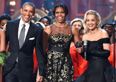 Holiday Cheer - U.S. President Barack Obama, First Lady Michelle Obama&nbsp;and Rita Ora speak onstage at the TNT 2014 Christmas at the National Building Museum in Washington, D.C.(Photo: Theo Wargo/WireImage)