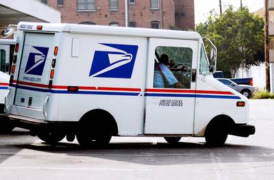 Postal Service - The bill requires the U.S. Postal Service to continue mail delivery six days a week, despite ongoing efforts to cut Saturday service to save money.  (Photo: Kevork Djansezian/Getty Images)