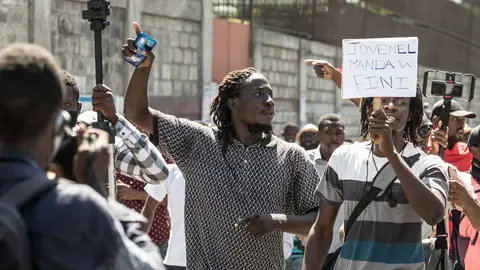 Demonstrators march in Port-au-Prince on February 10, 2021, to protest against the government of President Jovenel Moise. - Haitian police fired tear gas on hundreds of protesters who were marching against President Jovenel Moise and attacked journalists covering the demonstration, in the latest clashes to mark the country's political crisis. The protesters were accusing Moise of illegally extending his term. He says it lasts until February 2022 -- but the opposition argues it should have ended last weekend, in a standoff over disputed elections. (Photo by Valerie Baeriswyl / AFP) (Photo by VALERIE BAERISWYL/AFP via Getty Images)