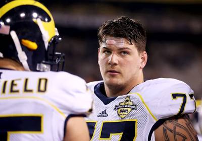 NFL Draft Prospect Taylor Lewan Facing Charges - Former Michigan offensive lineman, Taylor Lewan&nbsp;is facing three counts of assault. Lewan,&nbsp;a first-round NFL draft prospect, was charged with one count of aggravated assault and two counts&nbsp;of assault or assault and battery stemming from a Dec 1, 2013, incident. Two Ohio State fans said they were assaulted following Michigan's loss to Ohio State. Lewan, who is projected Top 10 pick in the NFL draft in May, will be arraigned April 8 in Michigan.(Photo: Christian Petersen/Getty Images)