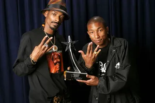 A Gang of Hits - Pharrell Williams has been making us &quot;Happy&quot; for years! Here, he and Uncle Snoop pose with their award for Best Collaboration for &quot;Beautiful&quot; back in 2003 at the third BET Awards.&nbsp;(Photo: Arnold Turner/WireImage for BET Entertainment)