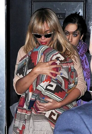 The Wrapture - Back from vacation in St. Barts, Beyoncé sports a new look with wing frame sunglasses and a flattering bang as she and a bundled baby Blue Ivy leave an office building in New York City.&nbsp;(Photo: AAR/FameFlynet Pictures)