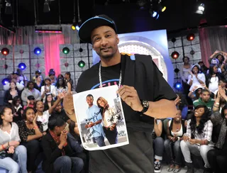 Sign Here - DJ Lyve shows autographed photo of Terrence J and Rocsi Diaz to be given to the livest audience member at 106 &amp; Park, April 11, 2012. (Photo: John Ricard / BET)
