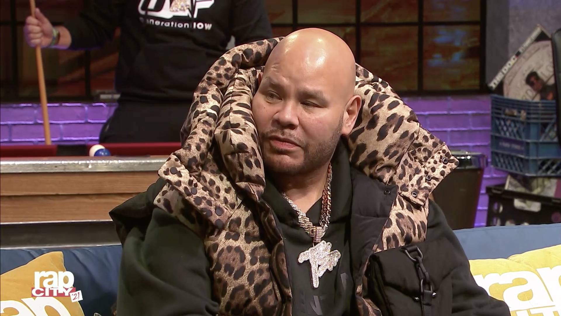 Fat Joe interviewed on Rap City in a big jacket with cheetah print.