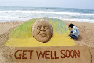 Well-Wishes Sent From Around the World - The iconic leader has also received an outpouring of support from the international community. In Puri, India, artist Sudarshan Pattnaik built a sand sculpture created in the likeness of Mandela to wish him a speedy recovery.&nbsp; President Obama and Michelle Obama wished Mandela a &quot;speedy recovery&quot; on Tuesday (June 11).&nbsp;(Photo: REUTERS/Stringer)