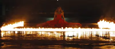 Up In Flames - Clad in a red gown which bears a striking resemblance to her wedding dress, Bey walks us through the rituals of sex while surrounded by flames.(Photo: HBO)