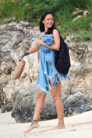 Rihanna - A barefoot Rih hits the beach in her native Barbados with a smile that shines bright like a diamond.(Photo: Splash News/Splash News/Corbis)