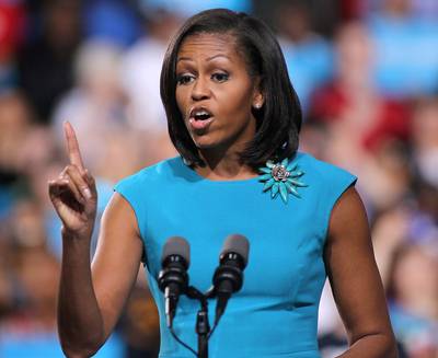 Michelle Obama's Fired Up - First Lady Michelle Obama helped warm up the crowd before the president spoke on Saturday. ?It sounds like you all are already fired up and ready to go,? said Obama to cheers, in an outfit that matched the sea of blue campaign signs rally attendees waved. ?Let me tell you, I?m pretty fired up and ready to go myself.?(Photo: Scott Olson/Getty Images)