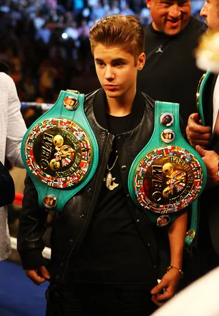 Mayweather's Valet - Bieber holds two belts for Mayweather before the champ takes on Cotto.(Photo: Al Bello/Getty Images)
