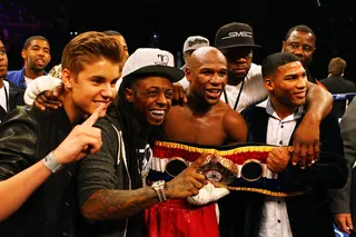Odd Coupling - This is an interesting cast of characters, to say the least. Pop star Justin Bieber, Lil Wayne and Curtis "50 Cent" Jackson pose with victorious&nbsp;boxer Floyd Mayweather Jr. after he defeated Miguel Cotto by unanimous decision in their WBA super welterweight title fight. The event was held at the MGM Grand Garden Arena in Las Vegas.   (Photo: Al Bello/Getty Images)