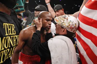 Words of Support - Mayweather gets last-minute instructions from his trainer before heading into the ring. He entered — and left — the ring undefeated.&nbsp;(Photo: AP Photo/Eric Jamison)