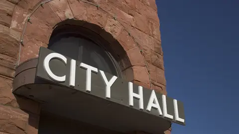 City Hall sign on brick building.