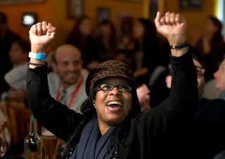 London - An Obama supporter cheered while watching coverage of the elections at an event in London. (Photo: Bethany Clarke/Getty Images)