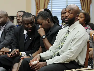 Benjamin Crump, Sybrina Fulton and Tracy Martin - Sybrina Fulton consults with family attorney Benjamin Crump during a congressional forum on Trayvon's death.(Photo: REUTERS/Jason Reed)