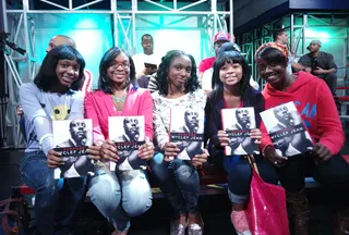 Audience Members Get a Copy of Wyclef's New Book  - Audience members with free copies of Wyclef Jean's new book "Purpose" at 106 &amp; Park, September 17, 2012. (Photo: John Ricard / BET).