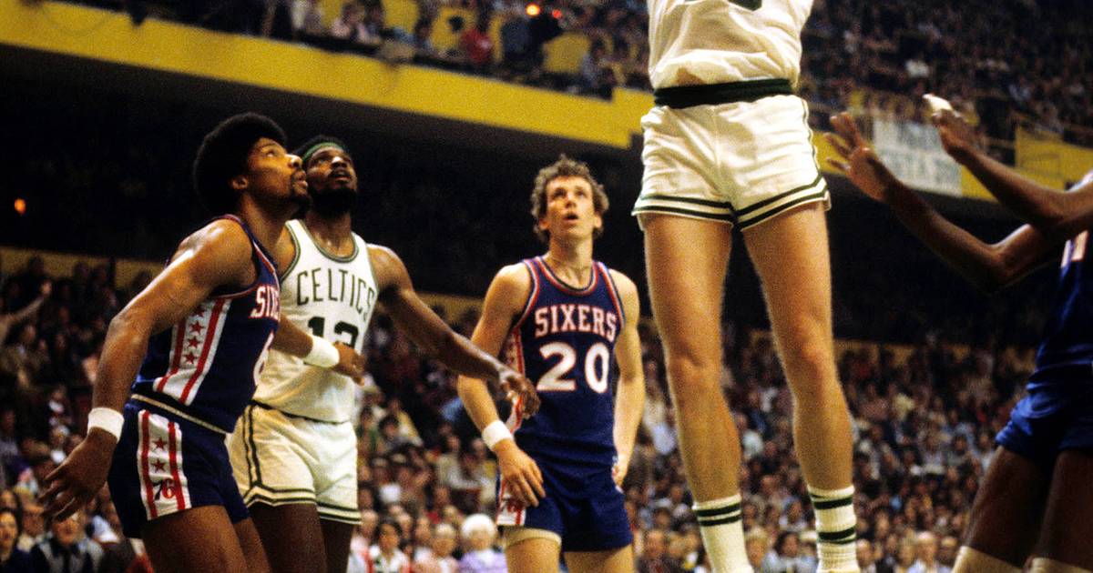 Former Boston Celtic Dave Cowens posing for a group picture with a