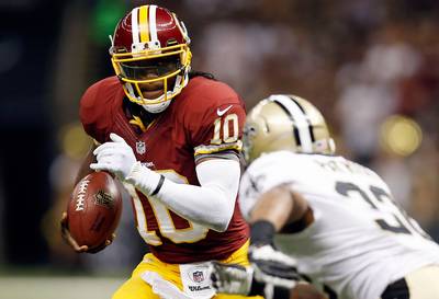 Not Bad, Rookie - In his official National Football League debut, Washington Redskins quarterback Robert Griffin III had an explosive match against New Orleans Saints, leading the Redskins to a 40-32 victory on Sunday.&nbsp;(Photo: Chris Graythen/Getty Images)