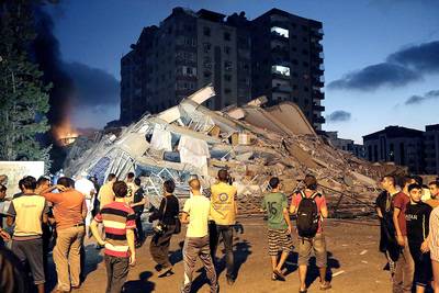 An Apartment Collapses - On Aug. 23, the Israeli military launched missiles at an apartment tower in downtown Gaza, collapsing the 12-story residence in an unprecedented strike, AP reports. A number of residents fled the building after a warning missile was fired five minutes earlier, but, according to Gaza hospital officials, 22 people were injured, including 11 children and five women.The military claimed it was targeting a Hamas operation room in the building.(Photo: Adel Hana/AP Photo)