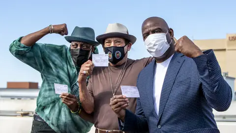 LOS ANGELES, CA - MARCH  24, 2021: Arsenio Hall, left, Danny Trejo and Magic Johnson pose for a photo after they all got vaccine shots  on the rooftop of parking structure at USC as a part of a vaccination awareness event at USC  on March 24, 2021 in Los Angeles, California. (Gina Ferazzi / Los Angeles Times via Getty Images)