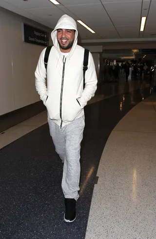 Jet-Setting - French Montana popped his hood as he arrived into LAX airport in a gray tracksuit. (Photo: PacificCoastNews)