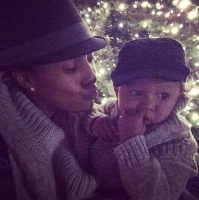 Tamera Mowry  - Taking in the twinkling lights, Tamera gets ready to plant a sweet one on the cheek of her adorable son Aden. So cute!  (Photo: Tamera Mowry via Instagram)