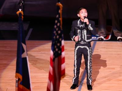 Mexican-American Boy?s National Anthem Sparks Racist Comments - When Sebastien De La Cruz, 11, performed his rendition of the National Anthem during Game 3 of the NBA Finals dressed in traditional Mexican attire there was nothing but applause, however off the court it was different story.&nbsp; People&nbsp;took to Twitter make fun of his attire and challenge his American citizenship:&nbsp;&quot;How you singing the national anthem looking like an illegal immigrant,? were among the negative tweets.&nbsp;(Photo: Mike Ehrmann/Getty Images)
