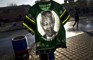 Clothing Memorabilia  - A T-shirt bearing the image of Nelson Mandela is displayed for sale on a street in Soweto township in South Africa.&nbsp; (Photo: AP Photo/Muhammed Muheisen, File)