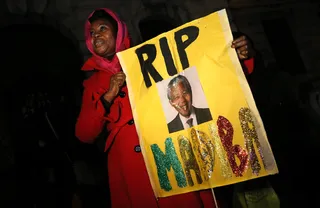 Mourners Gather in London - A woman holds an &quot;RIP&quot; sign at a gathering in memory of Nelson Mandela outside of the South African High Commission in London on Dec. 5.(Photo: REUTERS/Suzanne Plunkett)