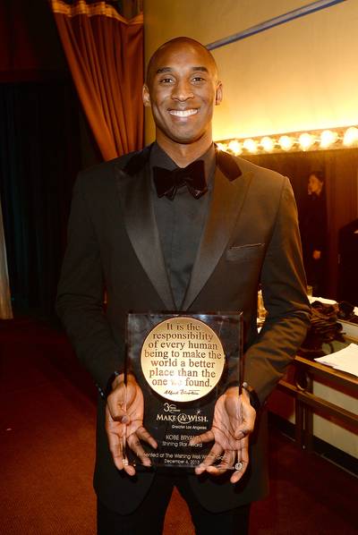 Perfect Gentleman - NBA basketball star Kobe Bryant proudly poses with his award after being honored for his charitable works at the Make-A-Wish Foundation 30th Anniversary Gala in Los Angeles. (Photo: Jason Merritt/Getty Images for Make-A-Wish Greater Los Angeles)