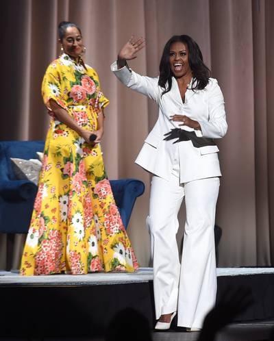 Powerful In A Power Suit - For a stop on her Becoming book tour, our forever first lady stunned in an all-white outfit while having an intimate conversation with Tracee Ellis Ross.&nbsp;(Photo: Kevin Winter/Getty Images)