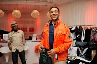 Orange Crush - Actor Harry Lennix tries on a fly orange jacket from the Celebrity Gift Suite on Saturday.&nbsp;(Photo by Valerie Goodloe/PictureGroup)