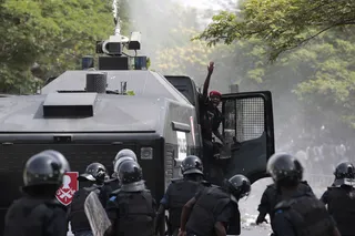 Reinforcements Are Rallied - A policeman in a water cannon shouts for reinforcements as riot police drive back demonstrators.(Photo: AP Photo/Rebecca Blackwell)