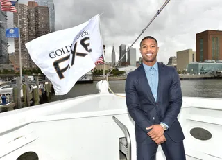 Captain Captivate - Michael B. Jordan&nbsp;is handsome in a blue suit celebrating the new AXE Gold Temptation fragrance line on a yacht at Pier 81 in New York City. (Photo: Mike Coppola/Getty Images for Axe)