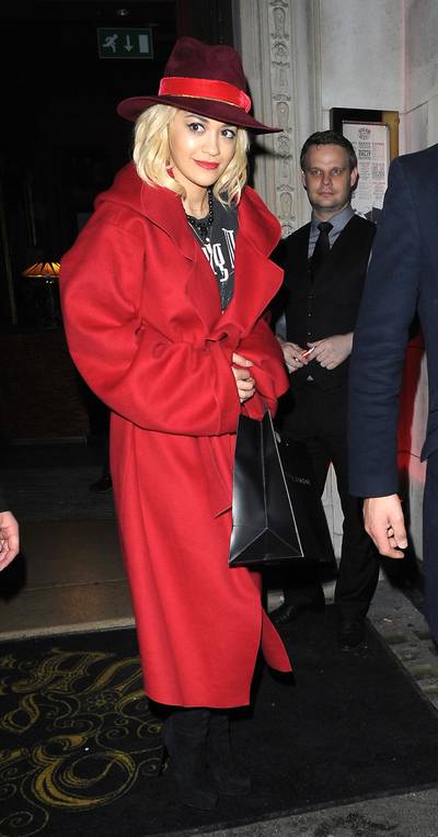 Live It Up - Rita Ora&nbsp;channels Carmen San Diego in her red overcoat and hat while leaving London cocktail bar and nightclub Steam &amp; Rye with her boyfriend, Ricky Hilfiger (not pictured). &nbsp;(Photo: PacificCoastNews)