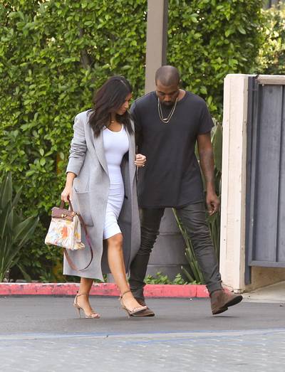 The Mama and the Papa - Kim Kardashian and Kanye West head into a building together in Los Angeles with Kimmie sporting her hand-painted Hermes handbag, a birthday gift from baby North. (Photo: INFphoto.com)