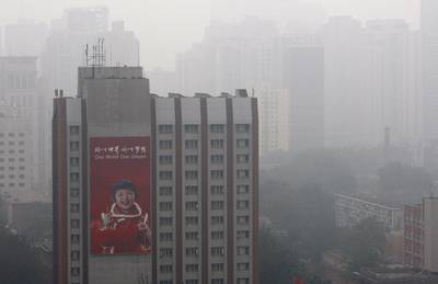 China Gets Real About Its Smog Problem - While Africa toughens its stance on outside polluters, China, one of the world’s biggest emissions producers, came to terms with its smog problem that has forced airlines to delay flights and commuters to drive with headlights on all day.\rReporters at the Durban climate summit say that China gave “the few glimmers of hope at the stalled negotiations” in Durban, where &quot;photographers and television journalists swarmed around the chief Chinese negotiator, Xie Zhenhua, as he entered a news conference on Monday to announce his list of conditions for considering a legally-binding treaty on carbon emissions after 2020.&quot;\r\r(Photo: Paula Bronstein/Getty Images)